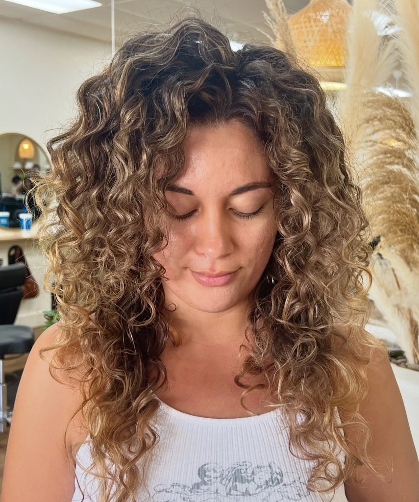 Embrace your natural curl pattern with these curl care tips. Learn about curl types and boost your hair confidence. Curls Gone Wild Salon is the premier curly hair salon in Gilbert, Arizona. Offering a comprehensive experience focusing on education, clients leave looking their best with their curly hair and also knowing how to take care of their curly hair.